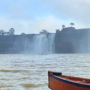 Bastar women group tour with F5 Escapes - A view of the majestic Chitrakote Waterfall in Bastar seen from a boat.