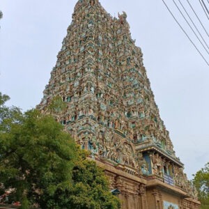 The highly detailed and colorful west tower (gopuram) of the Meenakshi Temple.