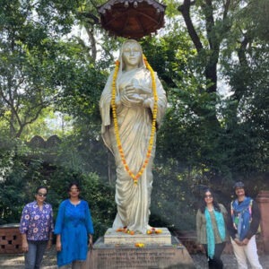 Mandu women only group tour with F5 Escapes - Women's group posing respectfully in front of the statue of Queen Ahilya Bai Holkar in Maheshwar.