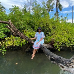 South Kerala & Kanyakumari women group tour with F5 Escapes - Woman traveler enjoying the serene backwaters of Munroe Island in Kerala.